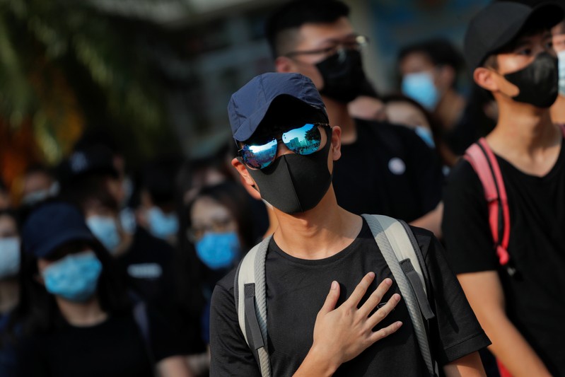 An alumnus of Tsuen Wan Public Ho Chuen Yiu Memorial College reacts during a student gathering at the school in solidarity with the student protester who was shot by a policeman on Tuesday in Tsuen Wan, Hong Kong