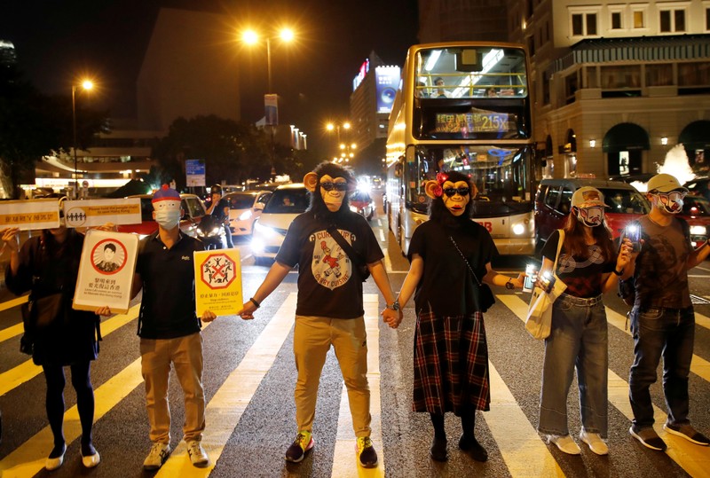 People wearing masks gather during an anti-government protest in Hong Kong