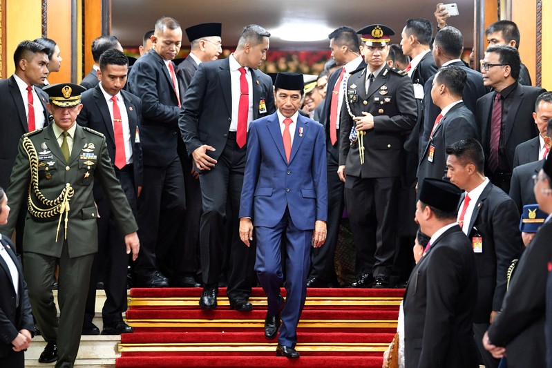 Indonesian President Joko Widodo walks after his inauguration and a swearing-in ceremony at the House of Representatives building in Jakarta