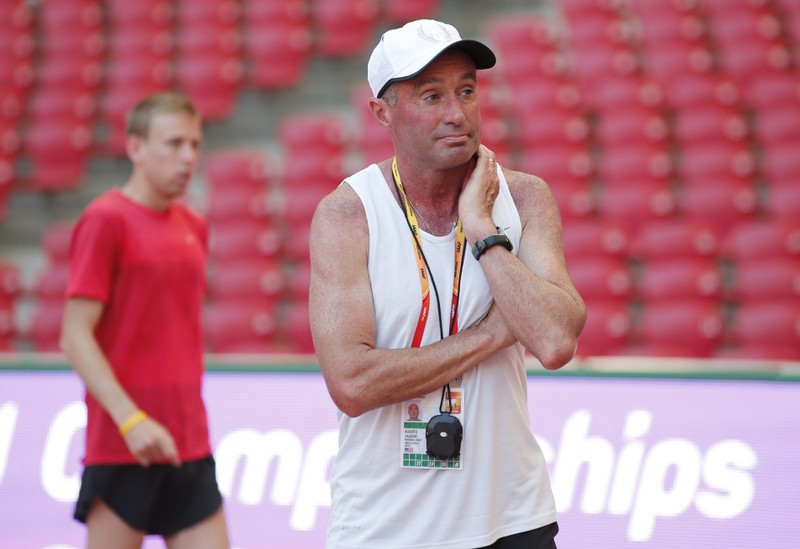 Coach Alberto Salazar stands in front of Galen Rupp of the U.S.A. in the Bird's Nest Stadium at the Wold Athletics Championships in Beijing