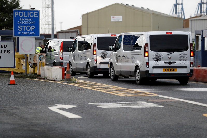 Vehicles of a funeral home arrive at the Port of Tilbury where the bodies of immigrants are being held by authorities, following their discovery in a lorry in Essex on Wednesday morning, in Tilbury