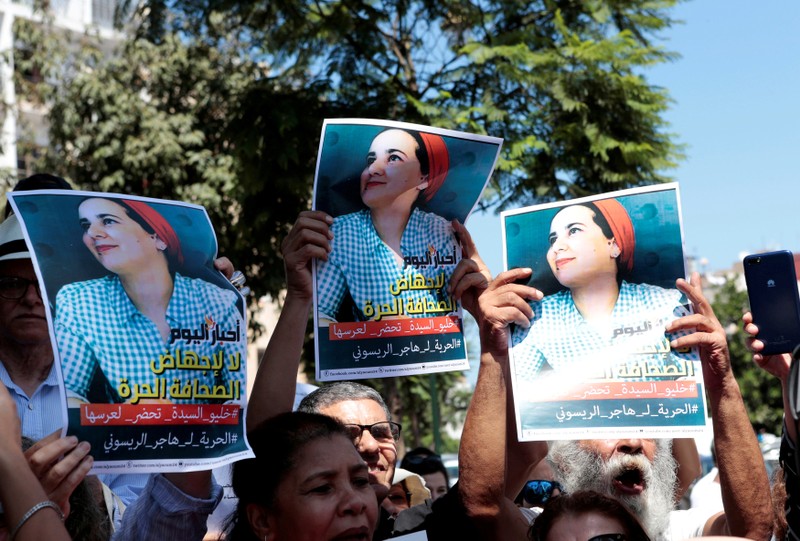 FILE PHOTO: Moroccan activists hold posters of Hajar Raissouni, a journalist charged with having sex before marriage and having an illegal abortion, during a protest outside the Rabat tribunal