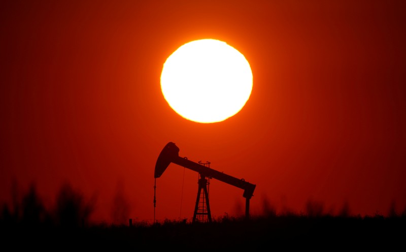 FILE PHOTO: The sun sets behind a pump-jack outside Saint-Fiacre