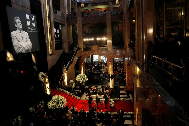 Family and friends stand next to the coffin of late Mexican singing legend Jose Jose during his tribute at Bellas Artes Palace in Mexico City