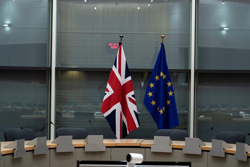 FILE PHOTO: British Union Jack and EU flags are pictured before the meeting with Britain's Brexit Secretary Barclay and EU's chief Brexit negotiator Barnier in Brussels