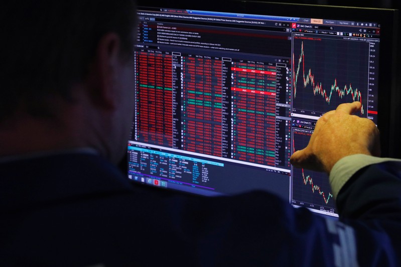 FILE PHOTO:A trader works on the floor of the New York Stock Exchange shortly after the opening bell in New York