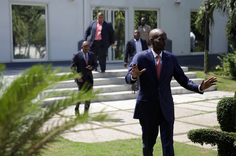 Haiti's President Jovenel Moise gestures as he arrives to a news conference in the gardens of the National Palace of Port-au-Prince