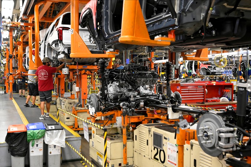 FILE PHOTO: FILE PHOTO: The engine and drive train are pictured with the body on the assembly line at the General Motors (GM) manufacturing plant in Spring Hill, Tennessee