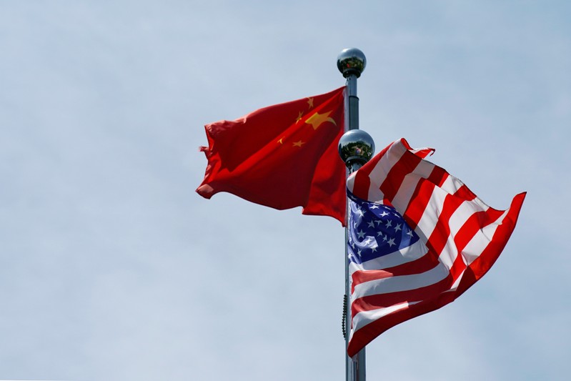 FILE PHOTO: Chinese and U.S. flags flutter near The Bund in Shanghai