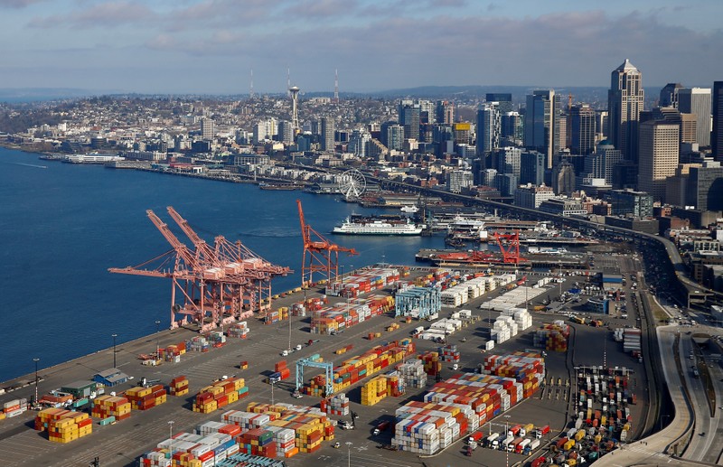 FILE PHOTO: An aerial photo looking north shows shipping containers at the Port of Seattle and the Elliott Bay waterfront in Seattle