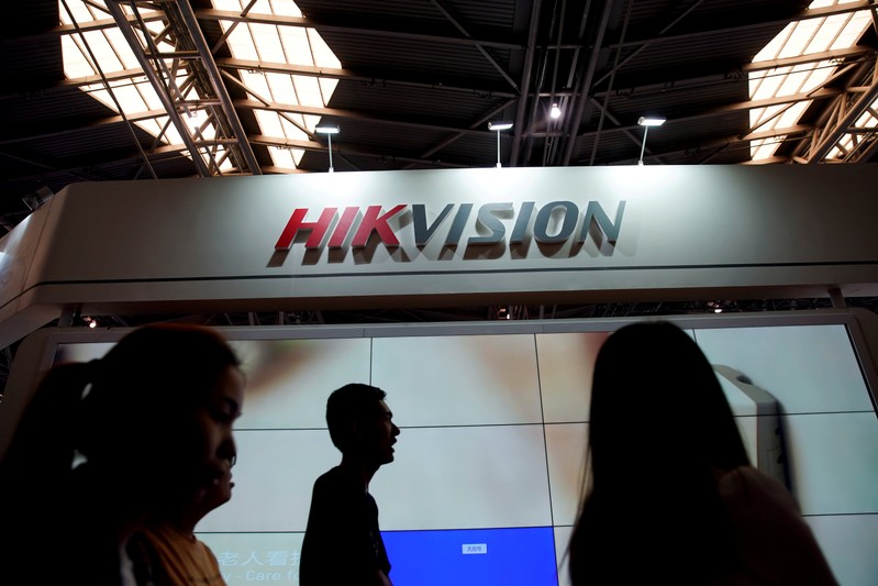 FILE PHOTO: People visit a Hikvision booth at a security exhibition in Shanghai