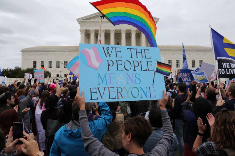 LGBTQ activists and supporters rally outside the U.S. Supreme Court in Washington