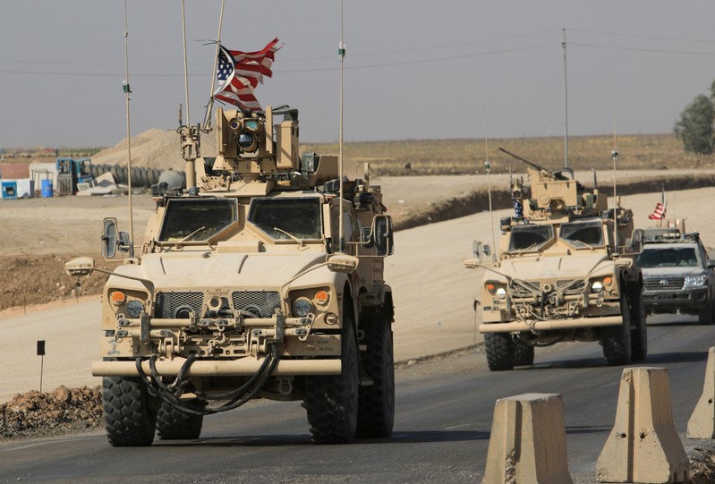 A convoy of U.S. vehicles is seen after withdrawing from northern Syria, at the Iraqi-Syrian border crossing in the outskirts of Dohuk