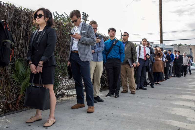 FILE PHOTO: Job seekers line up at TechFair in Los Angeles