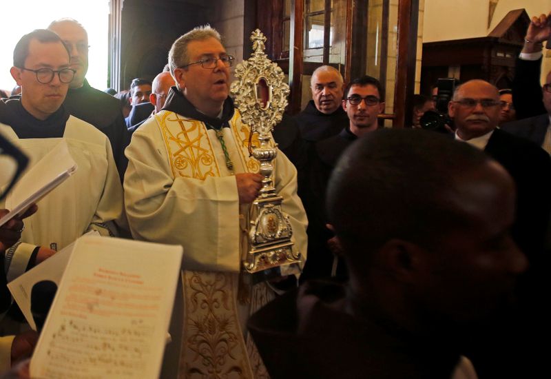 The Custodian of the Holy Land, Father Francesco Patton holds a wooden relic reputed to be part of Jesus's manger upon arrival at the Church of the Nativity in Bethlehem