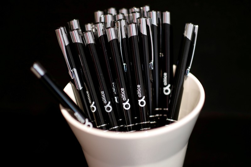 FILE PHOTO: Plastic pens with logos of Altice are pictured before a news conference in Paris
