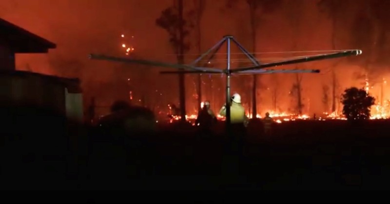 Firefighters look as a fire rages on in Rainbow Flat, New South Wales, Australia
