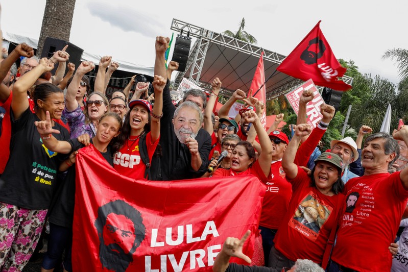 Supporters of Brazil's former President Luiz Inacio Lula da Silva gesture outside the Federal Police headquarters where Lula is serving a prison sentence, in Curitiba