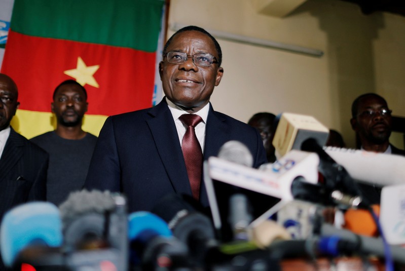 FILE PHOTO: Maurice Kamto, a presidential candidate of Renaissance Movement (MRC), smiles as he holds a news conference at his headquarter in Yaounde,
