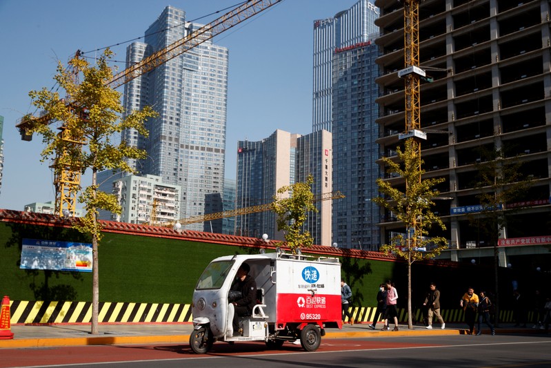 An electric delivery vehicle drives in the Central Business District in Beijing