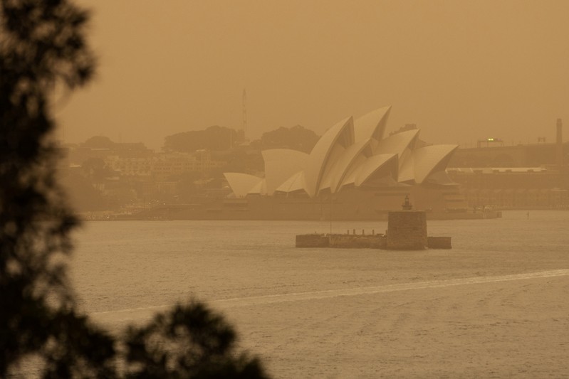 The Sydney Opera House is seen as smoke haze from bushfires drifts over the CDB in Sydney