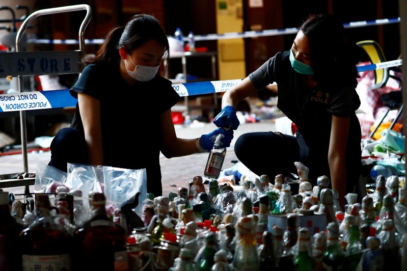 Police officers examine forensic evidence at the campus of the Polytechnic University (PolyU) in Hong Kong
