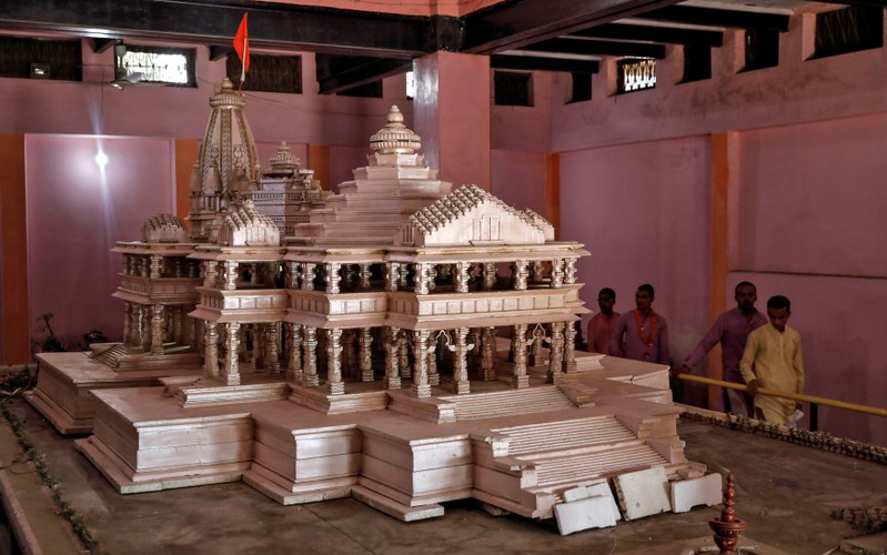 Devotees look at a model of the proposed Ram temple that Hindu groups want to build at a disputed religious site in Ayodhya