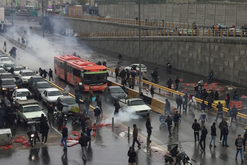 People protest against increased gas price, on a highway in Tehran