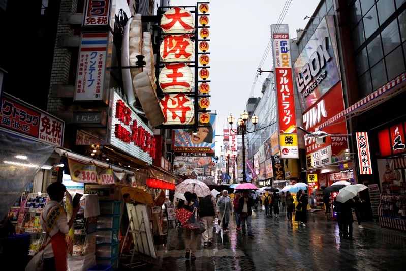 FILE PHOTO: People walk through a shopping district in Osaka