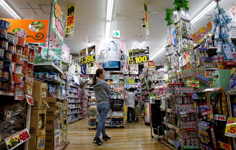 FILE PHOTO: Shoppers browse products at Japanese discount retailer Don Quijote Holdings' store in Tokyo