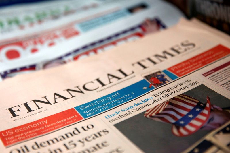 The cover of the Financial Times newspaper is seen with other papers at a news stand in New York