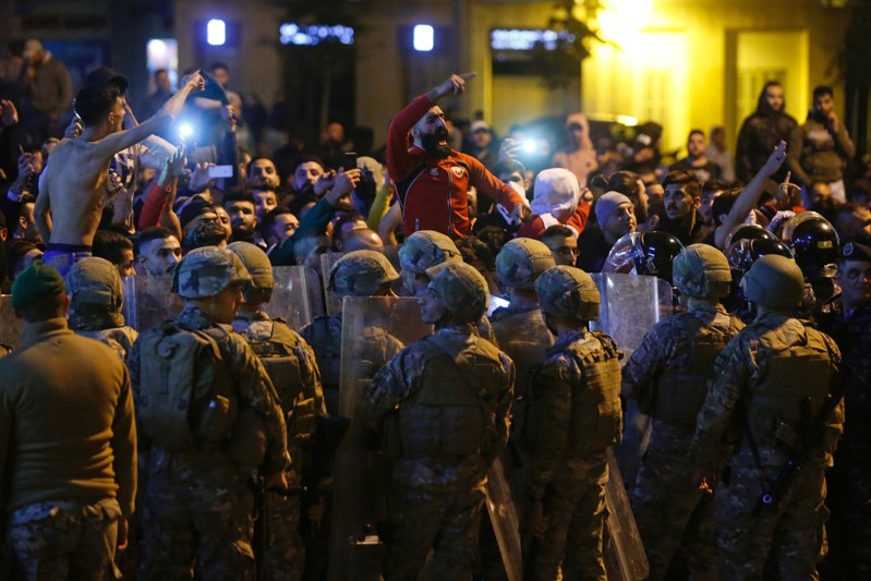 Lebanese army soldiers and riot police are deployed after clashes broke out between anti-government demonstrators and supporters of the Shi'ite movements Hezbollah and Amal in Beirut