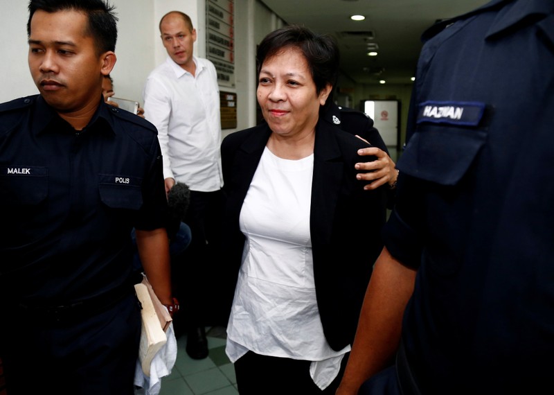 FILE PHOTO: Australian Maria Elvira Pinto Exposto is escorted as she arrives at a court in Shah Alam