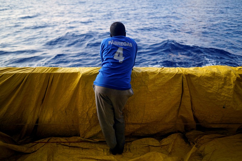 FILE PHOTO: A young Sudanese man stands on board an NGO rescue boat in central Mediterranean Sea