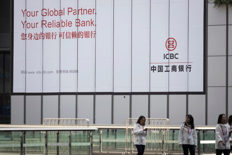 People walk past a sign of the Industrial and ICBC at the venue for the second China International Import Expo (CIIE) in Shanghai