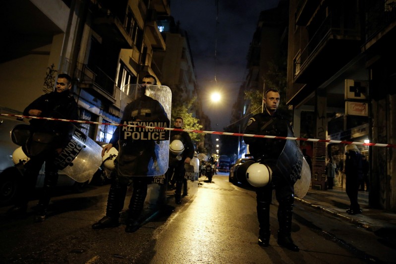 FILE PHOTO: Greek police secure the area after a gun attack outside the headquarters of Greece's socialist Pasok party in central Athens