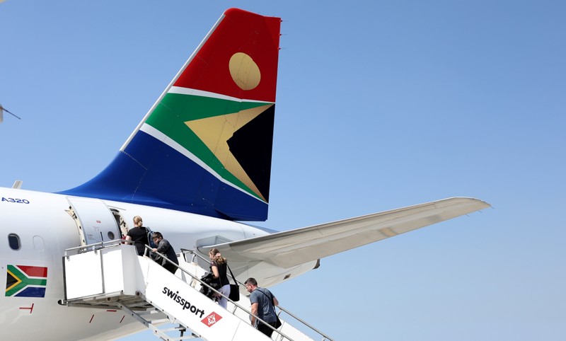 FILE PHOTO: Passengers board a South African Airways plane at the Port Elizabeth International Airport in the Eastern Cape province