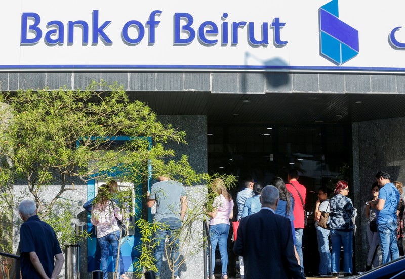 People queue outside a branch of Bank of Beirut in Ain el-Remmaneh