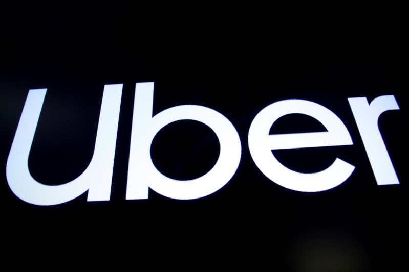 A screen displays the company logo for Uber Technologies Inc. on the day of it's IPO at the NYSE in New York