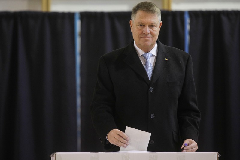 Incumbent candidate Klaus Iohannis casts his ballot in the second round of a presidential election