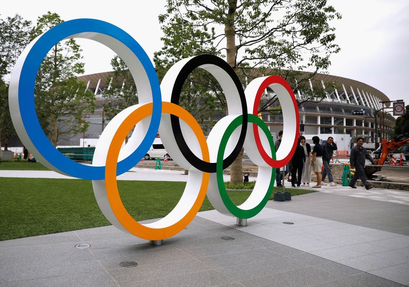FILE PHOTO: Olympic rings are displayed in front of the construction site of the New National Stadium, the main stadium of Tokyo 2020 Olympics and Paralympics, during a media opportunity in Tokyo