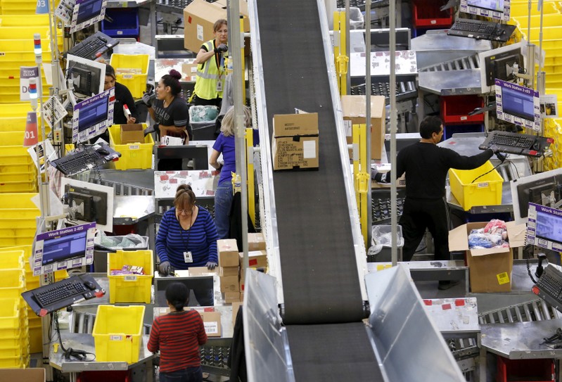 FILE PHOTO: Workers prepare orders at the Amazon Fulfillment Center in Tracy