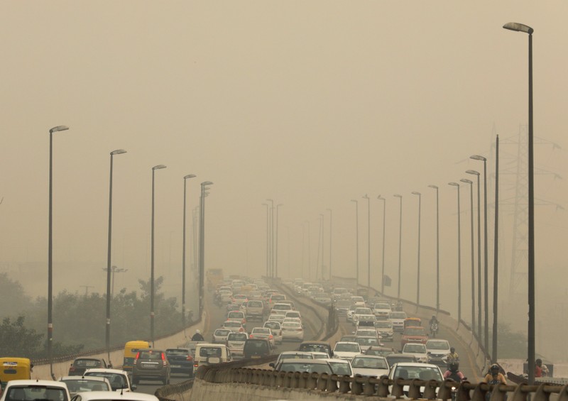 Vehicles drive among the smog in New Delhi