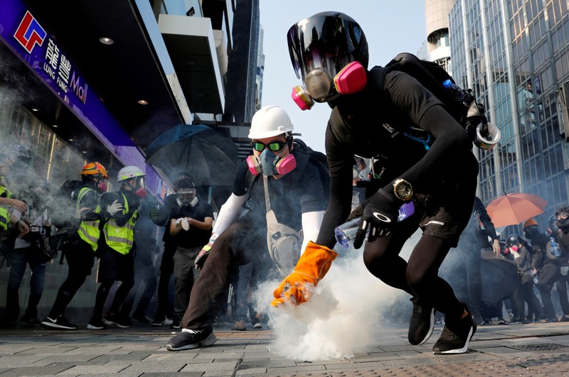 FILE PHOTO: An anti-government protester holds a tear gas canister during a protest in Hong Kong