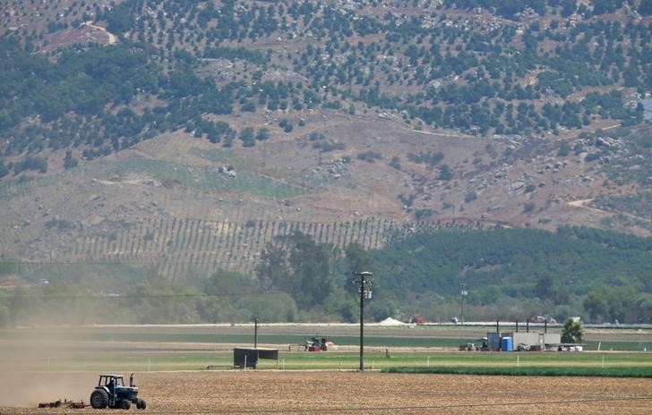 A farmer plows a field in the San Pasqual Valley near Escondido, California