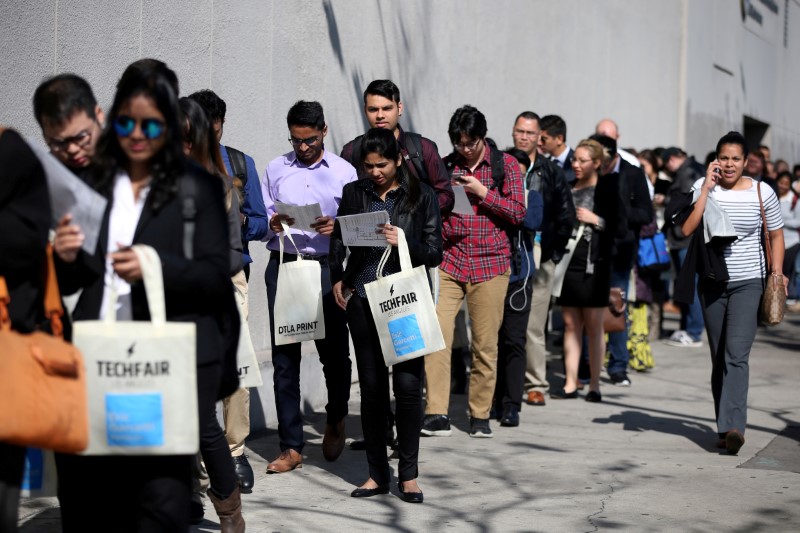 FILE PHOTO: People wait in line to attend TechFair LA, a technology job fair, in Los Angeles