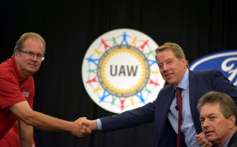 FILE PHOTO: UAW President Gary Jones shakes hands with Ford Motor Co Chairman Bill Ford at the start of contract talks between the union and the automaker in Detroit