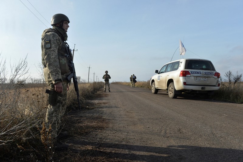 Ukrainian servicemen stand guard in the settlement of Bohdanivka in Donetsk Region