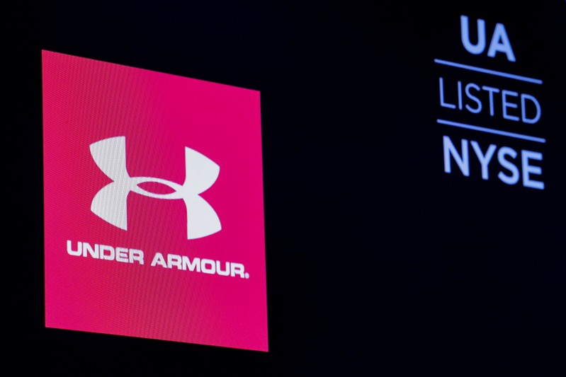 The ticker symbol and company logo for Under Armour, Inc. is displayed on a screen on the floor of the NYSE in New York