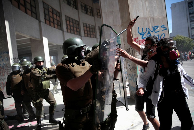 Demonstrators clash with riot policemen during a protest against Chile's government in Concepcion